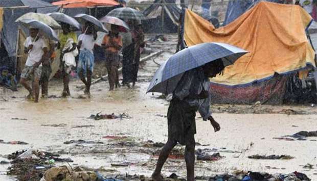 A Rohingya refugee holds an umbrella during heavy rain in Bangladesh's Balukhali refugee camp. File picture