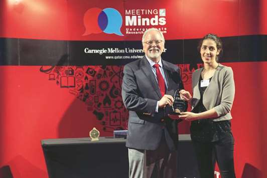 Fatima Tlili receives  Best Project award from CMU-Q dean Michael Trick.