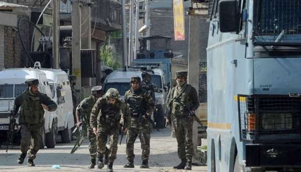 Indian security personnel react during a gunbattle between security forces and suspected rebels in Srinagar