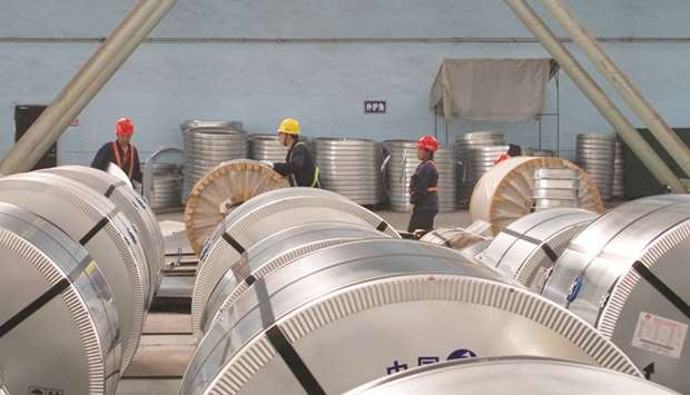 Workers pack cold rolled steel coil at a steel company in Zhangjiagang, Jiangsu province. Chinau2019s economy grew at a slightly faster-than-expected pace of 6.8% in the first quarter, but economists still expect growth to slow significantly by year-end.