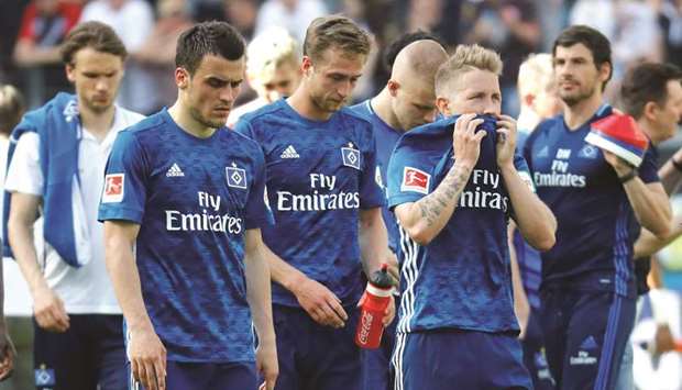 Hamburgu2019s players look dejected after losing their Bundesliga match to Eintracht Frankfurt yesterday. (AFP)