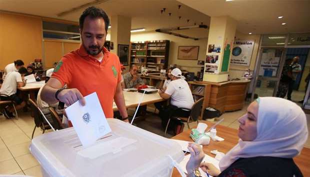 A man casts his vote at a polling station during the parliamentary election, in Sidon, Lebanon