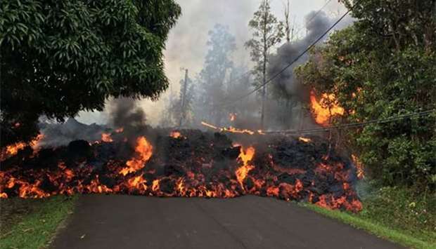 A lava flow from the Kilauea volcano moves on a street in Leilani Estates in Hawaii.