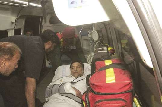 This handout photograph released by the Punjab Press Information Department (PID) on Sunday shows injured Interior Minister Iqbal being moved from a helicopter after he was air-lifted to Lahore.