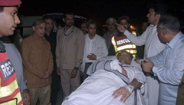 Officers and rescue workers move Pakistan's Interior Minister Ahsan Iqbal on a stretcher, after he was shot during a rally in Narowal and transported for medical attention to Lahore, Pakistan, yesterday.