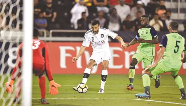 Al Saddu2019s Boualem Khoukhi (second from left) takes a shot at the Al Ain goal during the first leg of their Round of 16 match in AFC Champions League at the Al Sadd Stadium in Doha yesterday. PICTURE: Noushad Thekkayil