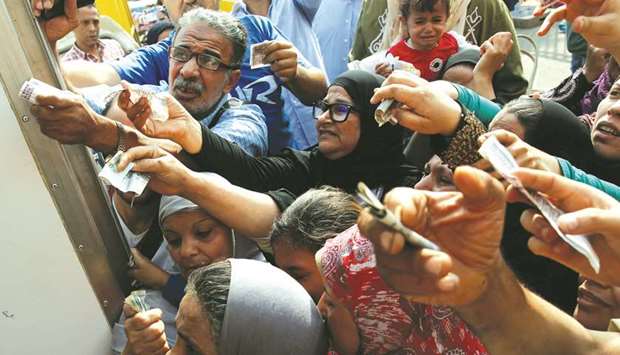 Egyptians gather to buy subsidised sugar from a government truck after a sugar shortage in retail stores across the country in Cairo in this file photo dated October 14, 2016. Egypt needs to embrace policies that strengthen the private sector and promote job growth to cement the gains realised from sweeping economic revival efforts, the IMF said.