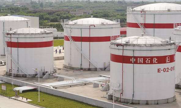Oil tanks are seen at a Sinopec plant in Hefei, Anhui province. Shares in Sinopec rose more than 2% yesterday as oil prices surged over 2% in Asia.