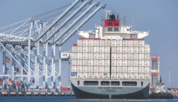 A tugboat guides a cargo ship into the Port of Long Beach in California. Trade deficit with China in March decreased 16.2% to an unadjusted $20.7bn, the lowest level since March 2014.