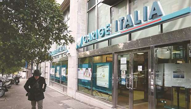 A pedestrian passes a Banca Carige bank branch in Rome. Under the plan explored by BlackRock, the firm would have taken up as much as u20ac400mn ($448mn) of a capital increase to take control of Carige.