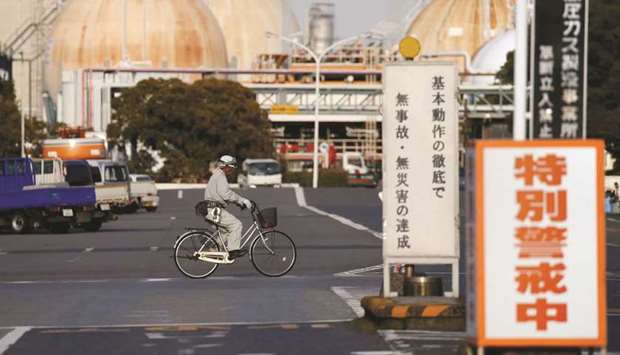 A worker riding a bicycle passes the Fuji Oil Cou2019s refinery in Sodegaura, Japan. Fuji Oil said Iranian oil accounted for about 20% of the companyu2019s supplies in the financial year through March, down from around 30% the previous year.