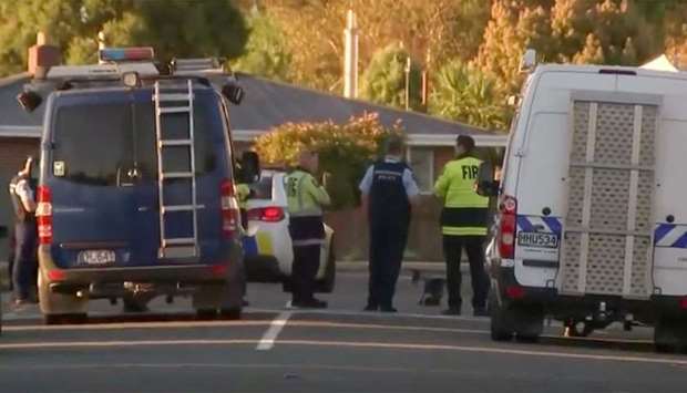Police officers and vehicles are seen behind police cordon, in Christchurch, New Zealand