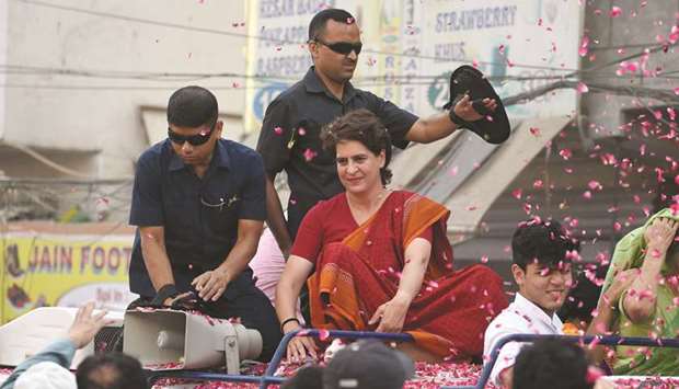 Priyanka Gandhi Vadra, Indian political leader and the Congress party general secretary for eastern Uttar Pradesh, is showered in petals during an election roadshow rally in New Delhi on May 8, 2019.