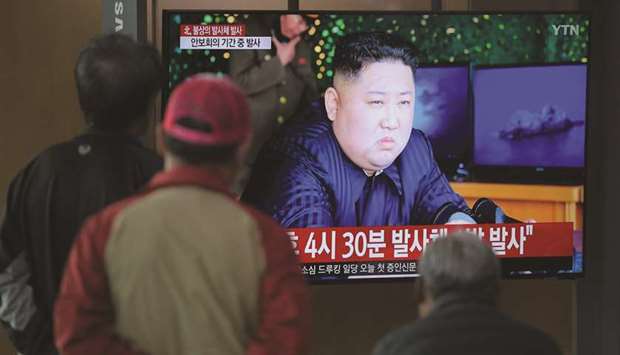 People watch a television news programme showing a picture of North Korean leader Kim Jong-un, at a railway station in Seoul on May 9. North Korea welcomed a US envoyu2019s visit to Seoul by firing at least one projectile for the second time in just six days on May 9, the Southu2019s military said, as Pyongyang seeks to up the ante in deadlocked nuclear negotiations with Washington.