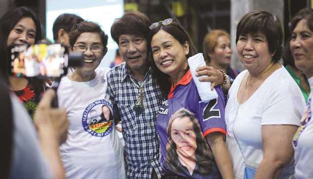 Gertrudes Batocabe (third right), wife of the late congressman Rodel Batocabe, posing for a photo with supporters during a campaign rally in the town of Daraga, Albay province, south of Manila.