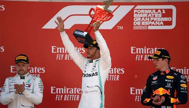 Mercedes' British driver Lewis Hamilton (C), first placed, Mercedes' Finnish driver Valtteri Bottas (L), second placed, and Red Bull's Dutch driver Max Verstappen, third placed, celebrate on the podium of the Spanish Formula One Grand Prix at the Circuit de Catalunya in Montmelo in the outskirts of Barcelona