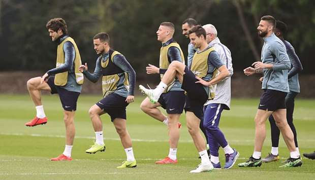 Chelsea star Eden Hazard (second right) trains with his teammates in Cobham, Britain, yesterday. (Reuters)