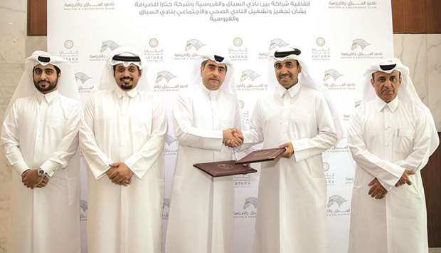 QREC Chairman Issa bin Mohammed al-Mohannadi and Chief Executive Officer of Katara Hospitality Hamad Abdulla al-Mulla pose with other officials.