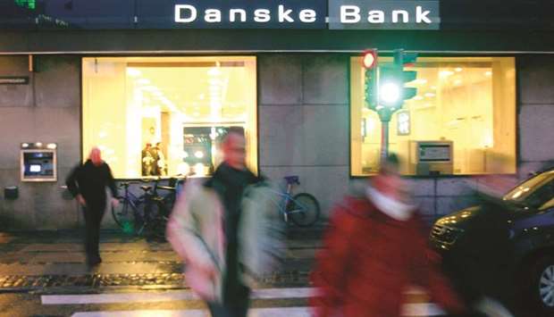 Pedestrians walk past a Danske Bank branch in Copenhagen. The bank admitted last year that it was at the centre of an unprecedented laundering scandal after failing to screen thousands of clients in Estonia. Much of the $230bn of mainly Russian money that flowed through those accounts was suspicious, Danske acknowledged.