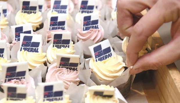 Liberal Party cupcakes are handed out to the party faithful and media before PM Morrisonu2019s address in Melbourne yesterday.