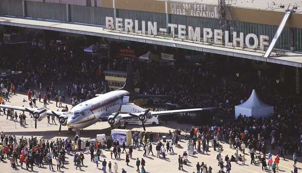 Visitors are seen around an original Douglas C-54, the so-called u2018Rosinenbomberu2019 (German for u2018Raisin bomberu2019), used at the Berlin airlift, during a celebration to mark the 70th anniversary of the airlift at the former Tempelhof Airport in Berlin.