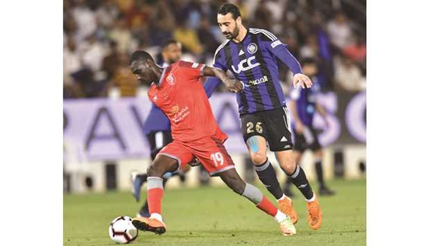 Al Duhailu2019s Almoez Ali (L) vies for the ball with Al Sailiyau2019s Bilal Mohamed.