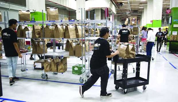 Employees prepare orders for shipping at an Amazon Prime Now fulfilment centre in Singapore.
