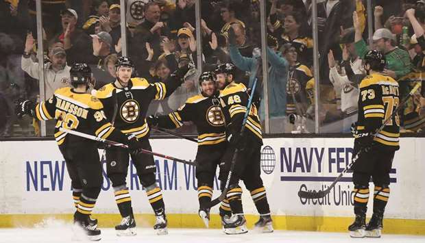 Matt Grzelcyk (third right) of the Boston Bruins celebrates with teammates after scoring a goal against Carolina Hurricanes in game two of the Eastern Conference Final during the NHL Stanley Cup playoffs. (AFP)