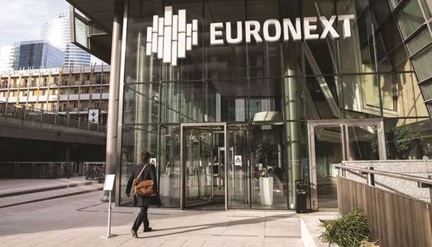 A visitor enters the Euronext stock exchange in La Defense business district of Paris. Euronext won the permission of the Norwegian government to buy the Oslo stock exchange without imposing an ownership threshold on the Franco-Dutch company.