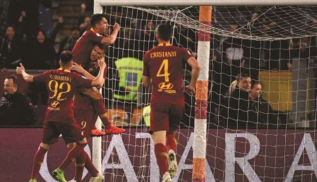 AS Roma players celebrate after scoring a goal against Juventus at the Olympic stadium in Rome on Sunday.