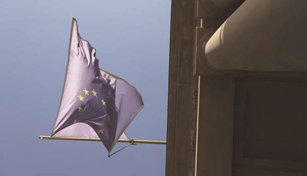 A European Union flag flutters outside the Frankfurt Stock Exchange. The DAX 30 ended 1.5% down at 11,876.65 points yesterday.
