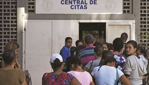 Patients queue outside the University Hospital in Caracas yesterday, during a nurses demo. Members of the board of directors of the nursing school of the capital district demonstrated to make public their critical work situation and to demand Venezuelan President Nicolas Maduro for explanations on the whereabouts of humanitarian aid.