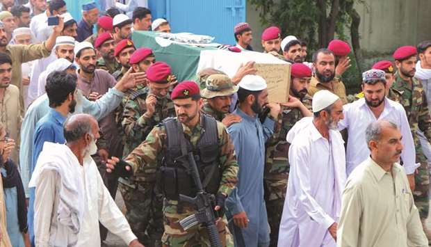 Soldiers and residents carry the coffin of a soldier, who was killed in the fight with gunmen at the five-star Pearl Continental Hotel in Gwadar, in Haripur district in Khyber Pukhtunkhwa province yesterday.