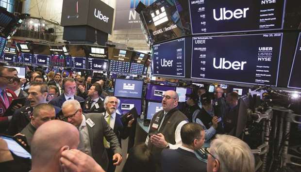 Traders work during Uberu2019s initial public offering on the floor of the New York Stock Exchange on Friday. The No 1 ride-hailing company has been one of the biggest victims of the market pullback, with the stock plunging 18% in its first two days of trading.