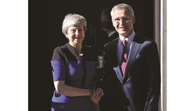 Prime Minister Theresa May shakes hands with Nato secretary general Jens Stoltenberg at Downing Street, in London yesterday.