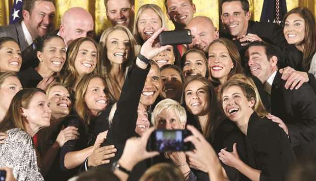 File photo of the then US President Barack Obama posing for a selfie taken by veteran star player Abby Wambach during an event at the White House honouring the United States womenu2019s national football team for their victory in the 2015 FIFA Womenu2019s World Cup.