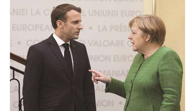 Macron and Merkel speak during the informal meeting of European Union leaders in Sibiu, Romania, earlier this month.