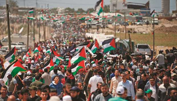 Palestinian demonstrators gather east of Gaza City yesterday during a protest marking the 71th anniversary of Nakba.