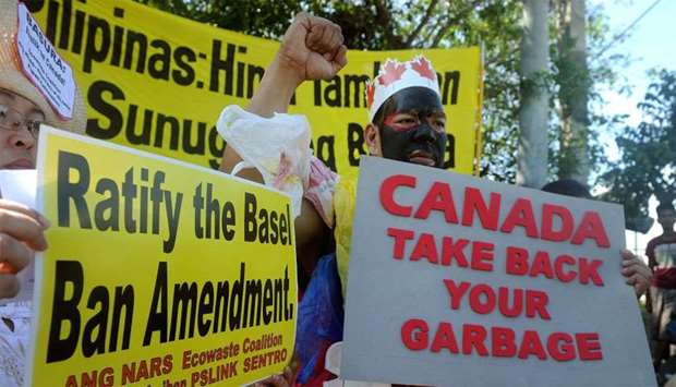 Environmental activists rallying outside the Philippine Senate in Manila to demand that scores of containers filled with household rubbish be shipped back to Canada