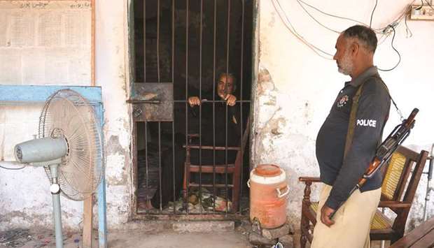 In this image taken on May 9, a Pakistani local paediatrician alleged to have been responsible for the HIV outbreak, is seen behind the bars at a local police station in Rato Dero, in the Sindh district of Larkana.