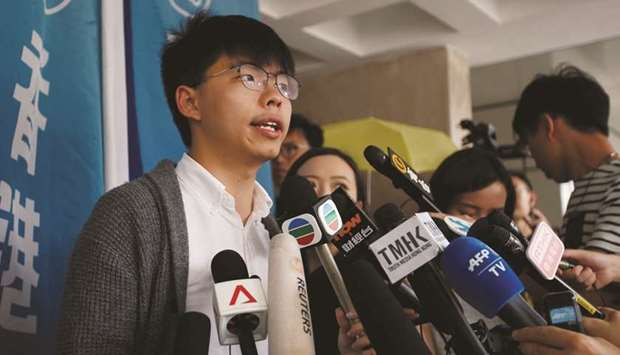 Hong Kongu2019s pro-democracy activist Joshua Wong speaks to members of the media at the High Court in Hong Kong, China, yesterday.
