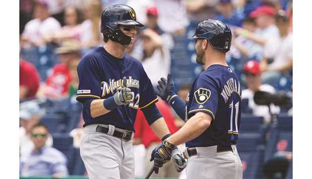 Milwaukee Brewers right fielder Christian Yelich (left) celebrates with teammate Mike Moustakas after hitting a home run in the first inning home against the Philadelphia Phillies at Citizens Bank Park in Philadelphia. (USA TODAY Sports)