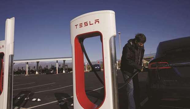 A driver charging a Tesla Model X electric vehicle at the Tesla Tejon Ranch Supercharger station in Lebec, California. Tesla is rolling out an over-the-air software update for two of its vehicles, including the flagship Model S, to improve safety and battery life.