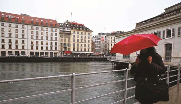 A pedestrian walks on the banks of River Rhone in Geneva. Although the city has largely recovered from the end of secrecy at banks, Geneva faces questions about its allure for international businesses and the worldu2019s wealthy.