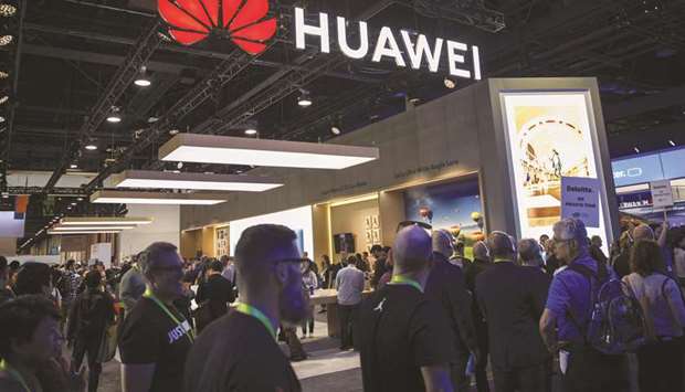 Attendees walk past the Huawei Technologies Co booth at the 2019 Consumer Electronics Show in Las Vegas, Nevada, on January 9. In a Federal Register notice released on Thursday, the US Commerce Department said the latest curbs apply to Huawei and 67 of its affiliates scattered across 26 countries from Germany to Madagascar.