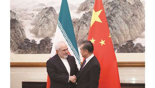 Chinau2019s Foreign Minister Wang Yi (right) shakes hands with Iranu2019s Foreign Minister Mohamed Javad Zarif at the Diaoyutai State Guesthouse in Beijing, yesterday.