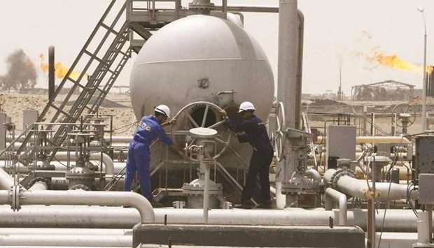 Workers of South Oil Company (SOC) adjust a valve at the Rumaila oilfield in Basra Province (file)