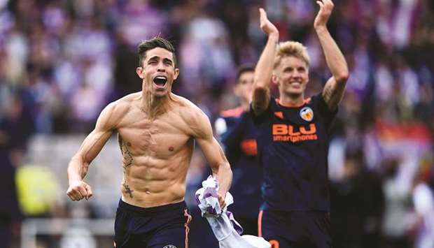 Valenciau2019s defender Gabriel Paulista (left) and midfielder Daniel Wass celebrate after their win over Real Valladolid in the La Liga at the Jose Zorrilla stadium in Valladolid, Spain, yesterday. (AFP)