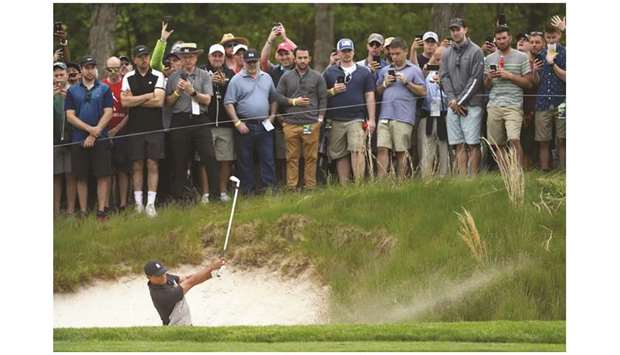 Tiger Woods of the United States plays a shot from a bunker on the 13th hole during the second round of the 2019 PGA Championship at the Bethpage Black course in Farmingdale, New York.