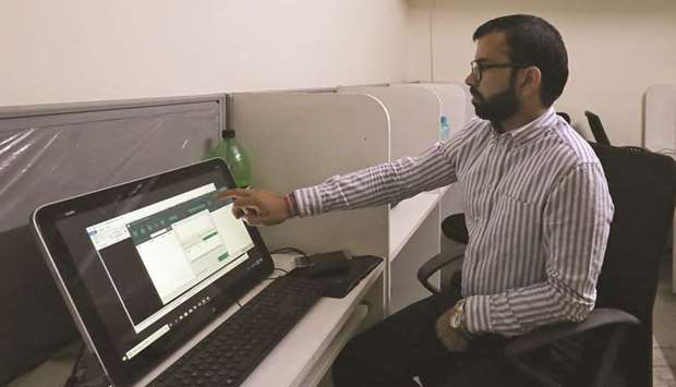 Rohitash Repswal, a digital marketer, shows a software tool that appears to automate the process of sending messages to WhatsApp users, on a screen inside his office in New Delhi, India, on May 8.